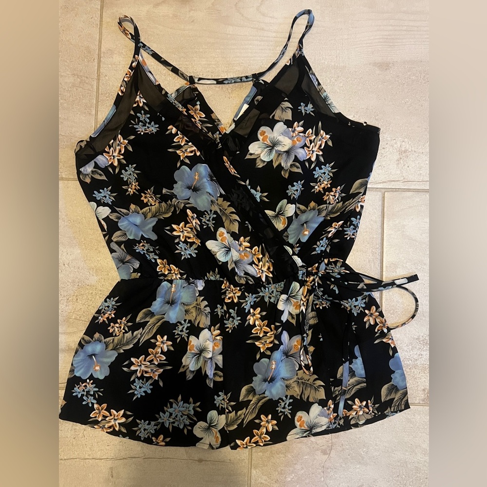 Sleeveless blouse with peplum waist.